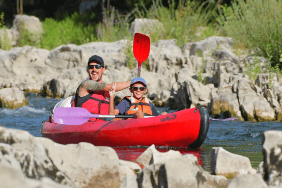 Adult and child kayaking together on the Mini Descent route, perfect for families