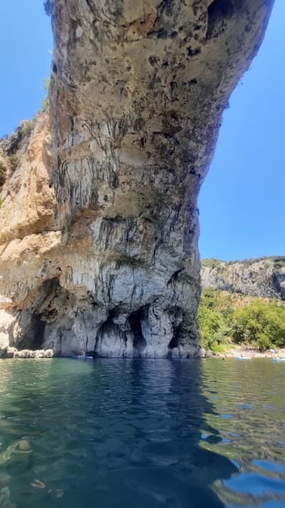 View from inside the natural arch showing the impressive limestone formations and geological layers