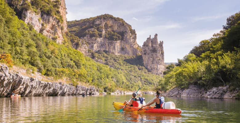 Two kayakers paddling through the gorge