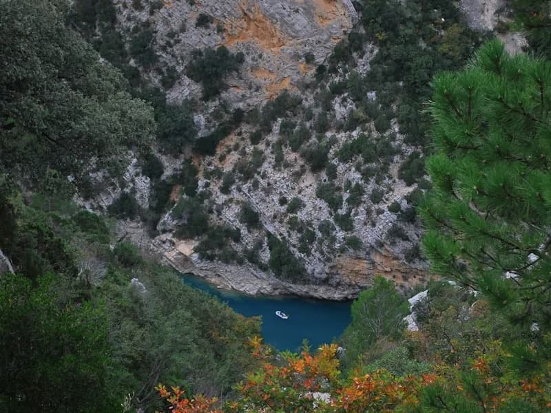 Lone paddler on the calm waters of the Ardèche river at sunset